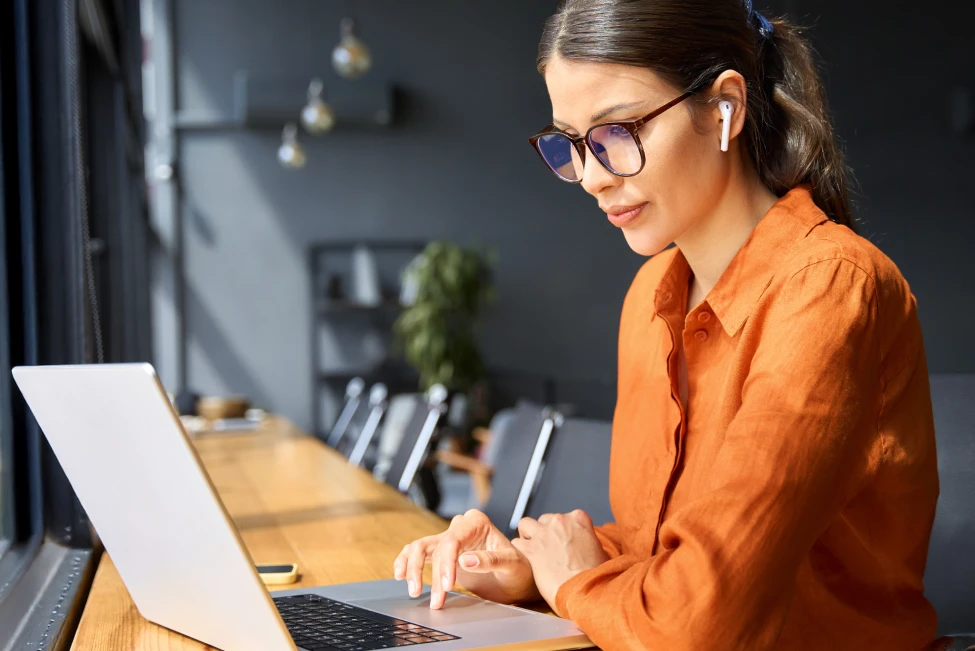 Woman working in campus amenity space at Riverfront office park
